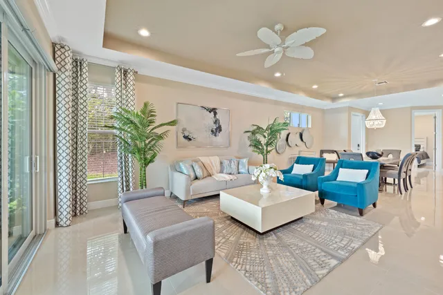 a living room with furniture and a chandelier