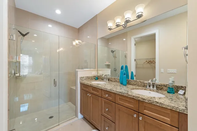 a bathroom with double sink and a mirror
