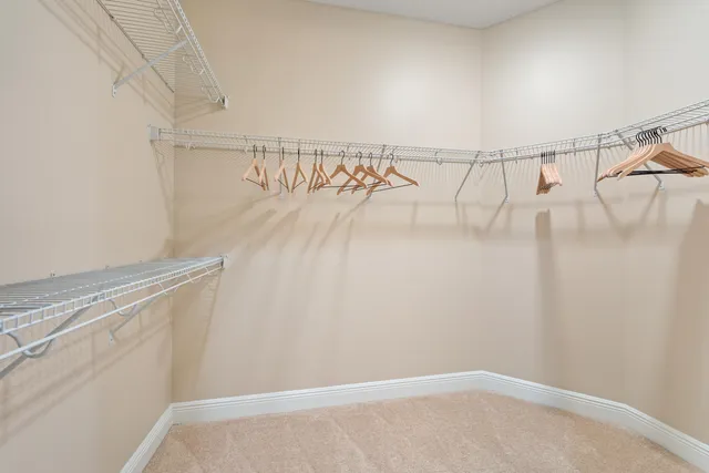a view of walk in closet with clothes