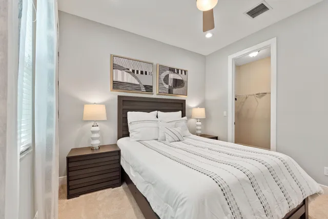 a bedroom with a bed and a lamp