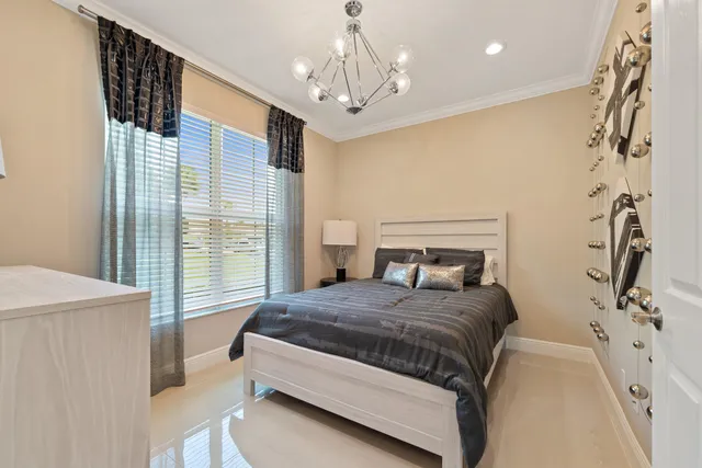 a bedroom with a bed and a chandelier