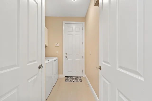 a view of a hallway with wooden floor and closet