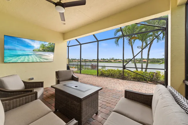 a living room with furniture and a floor to ceiling window