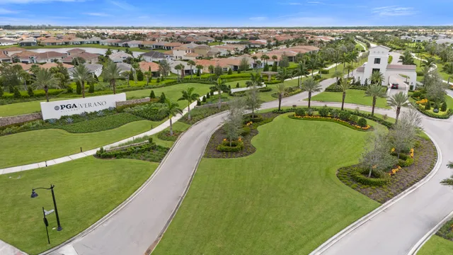 an aerial view of a residential houses with outdoor space and lake view