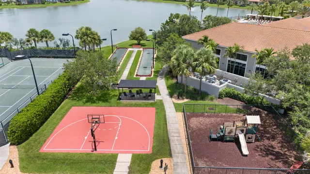 an aerial view of a house with outdoor space lake swimming pool and outdoor seating