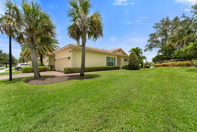 a front view of house with yard and tree