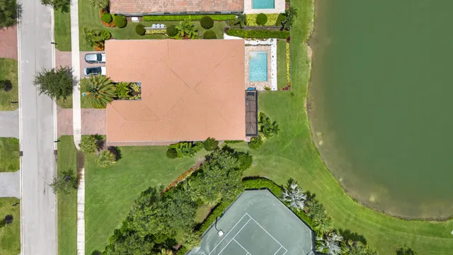 an aerial view of a residential houses with yard