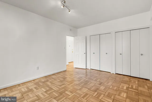 a bathroom with a granite countertop sink a toilet and a large mirror