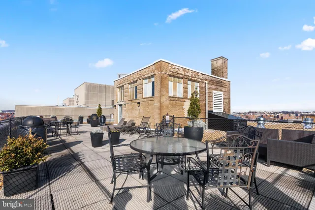 a open kitchen with stainless steel appliances and white cabinets