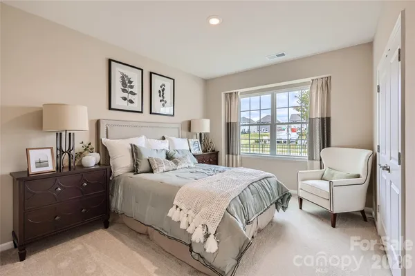 a bedroom with a bed and a couch