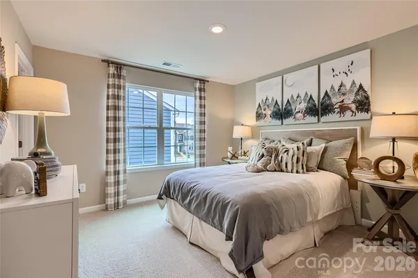 a bedroom with a bed and a lamp on table
