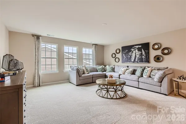 a living room with furniture and a floor to ceiling window