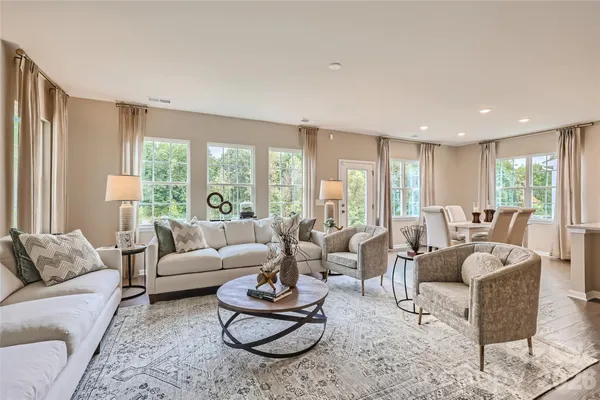 a living room with furniture and a large window with garden view