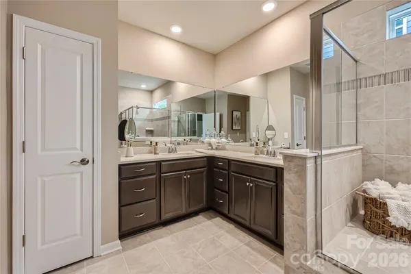 a bathroom with a double vanity sink and a mirror