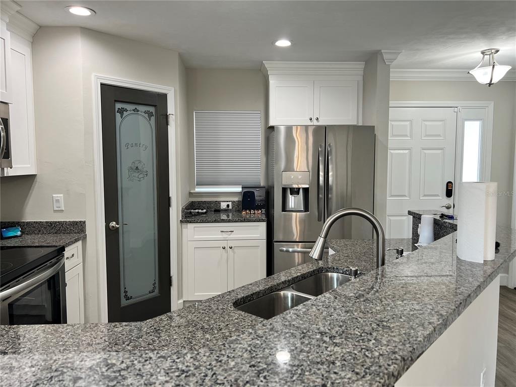 25107 Southwest 9th Lane Newberry, FL 32669 - Photo 3 of 9 a kitchen with a refrigerator and a sink