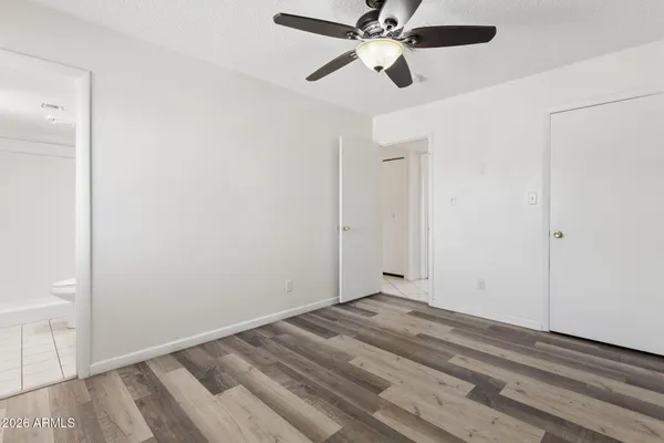 a view of empty room with wooden floor
