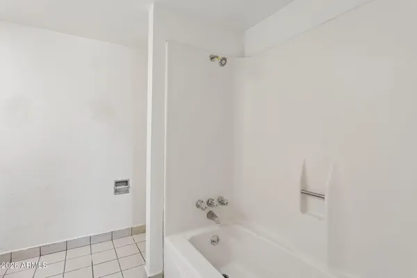 an empty room with a ceiling fan and wooden floor