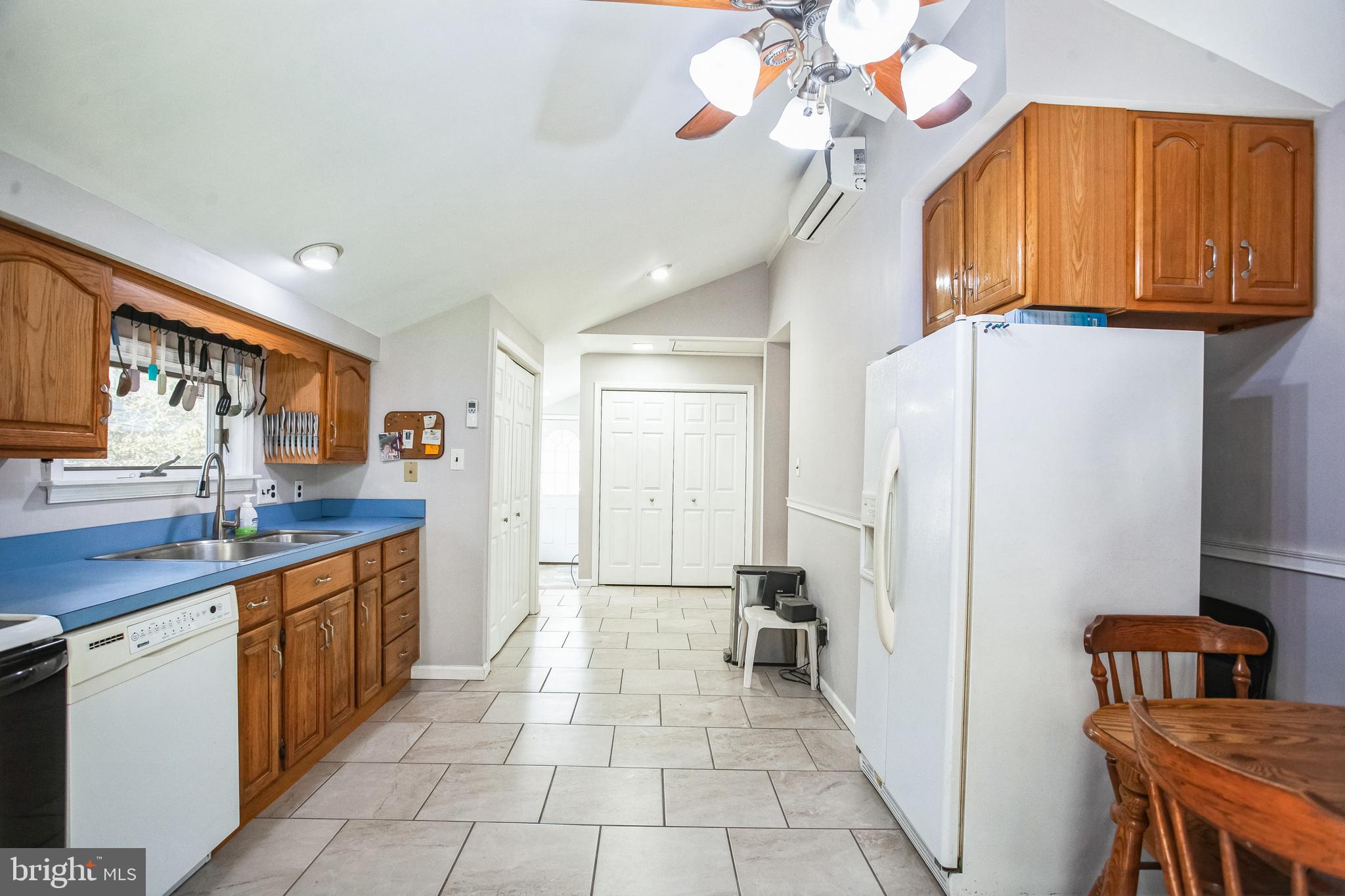 2775 Valley Road Jamison, PA 18929 - Photo 17 of 40 a kitchen with stainless steel appliances granite countertop a refrigerator a sink dishwasher a dining table and chairs with wooden floor