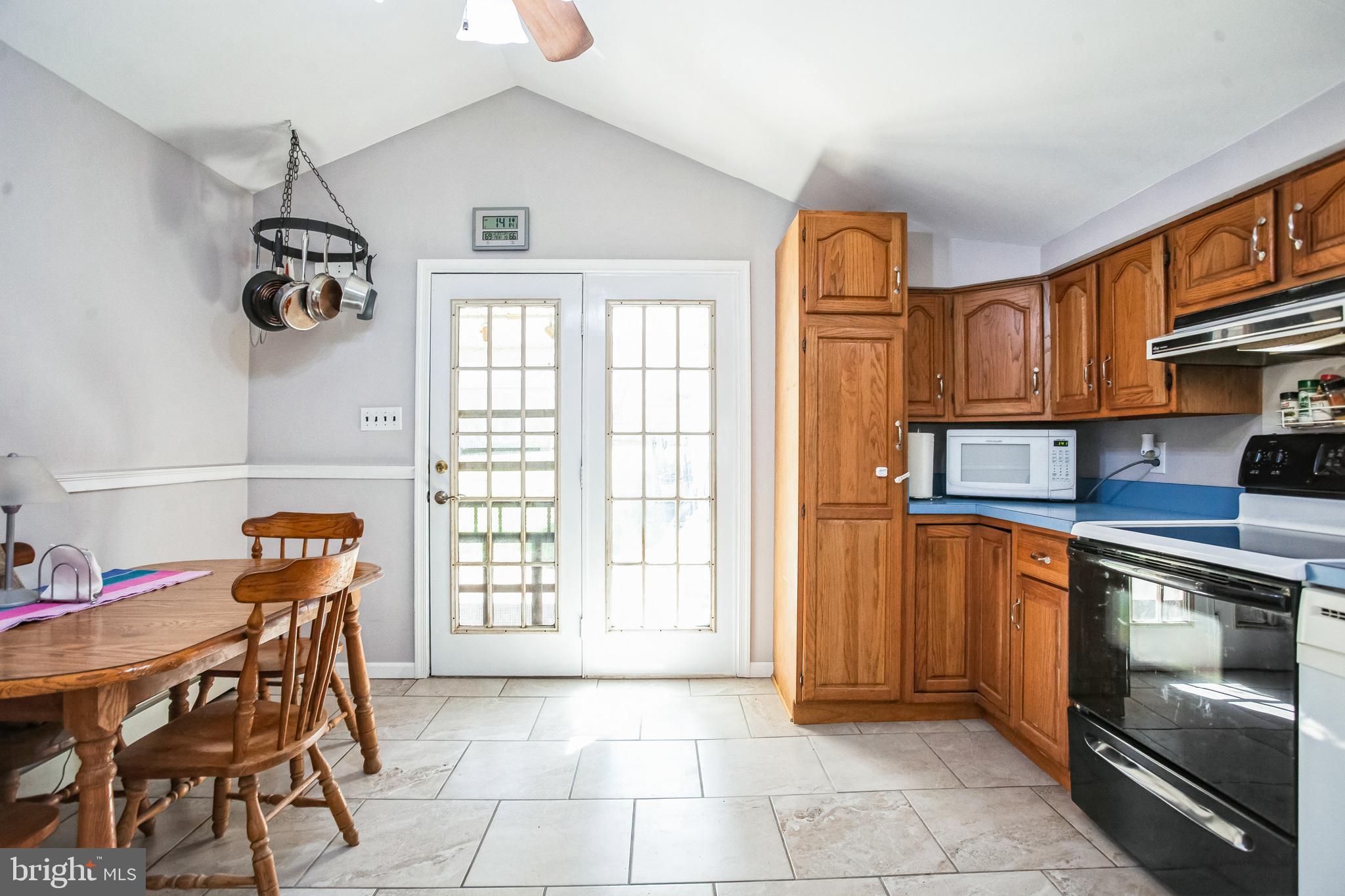 2775 Valley Road Jamison, PA 18929 - Photo 18 of 40 a kitchen with stainless steel appliances granite countertop a stove top oven a sink a dining table and chairs with wooden floor