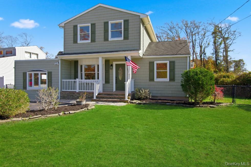 View of front of home featuring a porch and a shingled roof