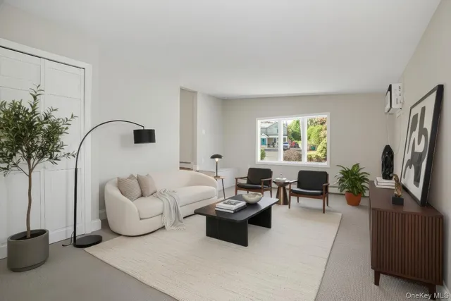a living room with furniture potted plant and a window