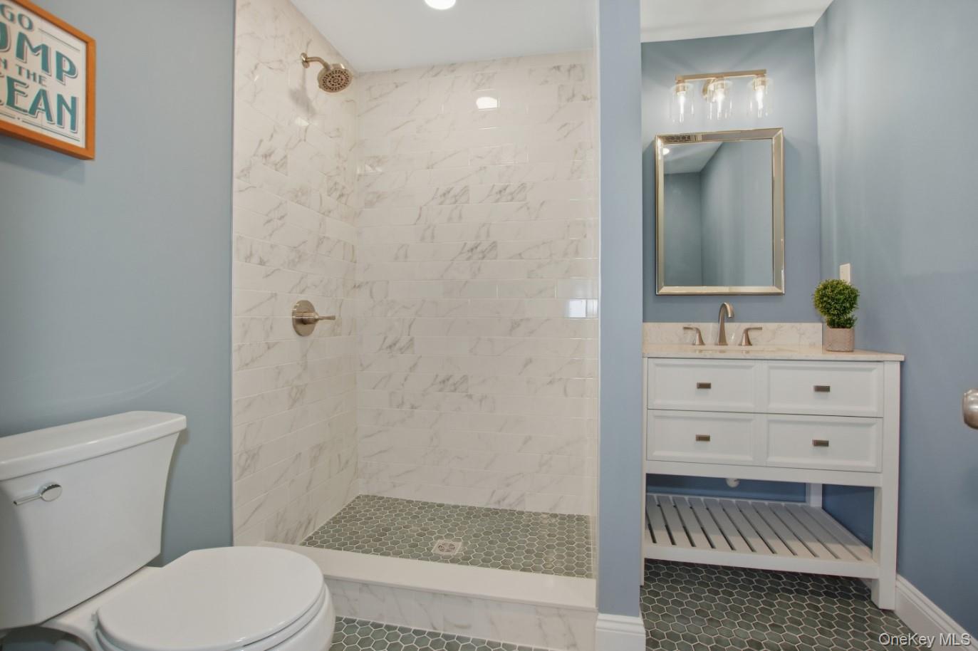 225 Lyman Road East Patchogue, NY 11772 - Photo 12 of 18 1st Floor Full bath featuring vanity, a stall shower, and dark tile patterned flooring
