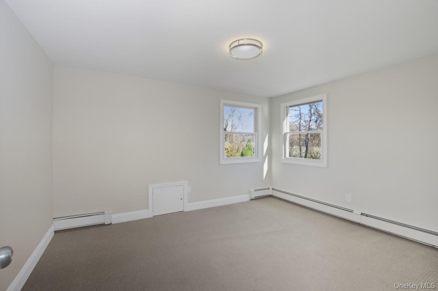 225 Lyman Road East Patchogue, NY 11772 - Photo 13 of 18 2nd floor Bedroom featuring carpet floors and a baseboard heating unit