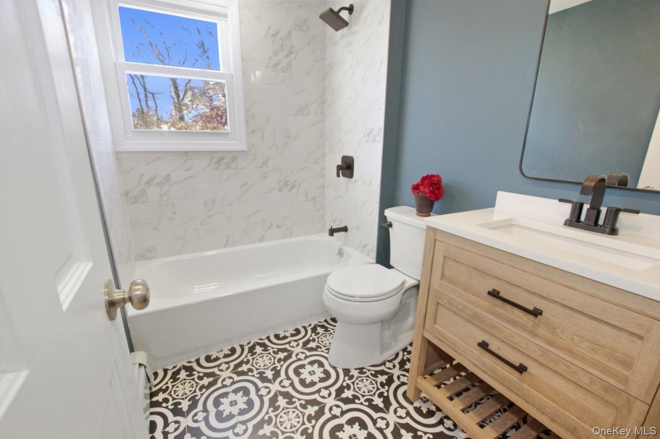 225 Lyman Road East Patchogue, NY 11772 - Photo 14 of 18 2nd Floor Full bath featuring vanity, shower / bath combination, and light tile patterned floors