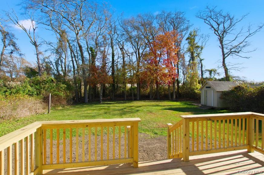 225 Lyman Road East Patchogue, NY 11772 - Photo 16 of 18 Deck featuring a yard and a shed