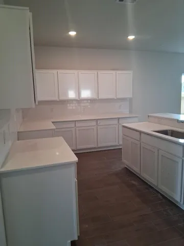 a kitchen with a sink stove and cabinets