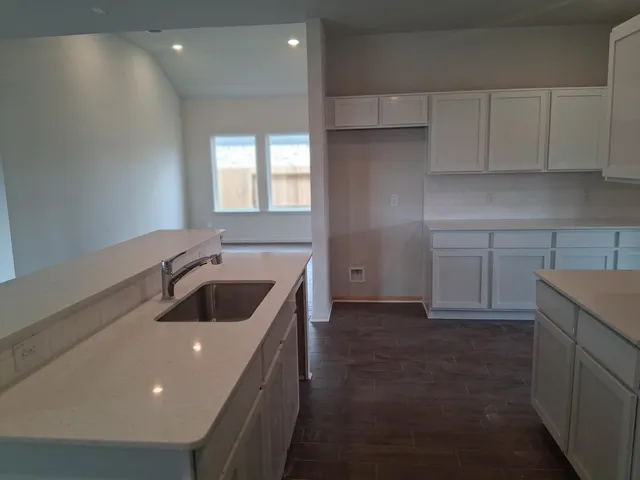 a kitchen with a sink and cabinets