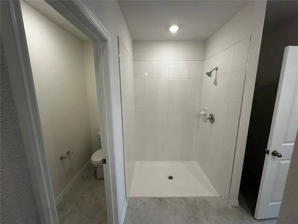 a bathroom with a shower and toilet