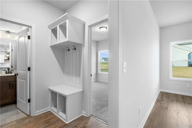 an entryway with wooden floor and cabinet