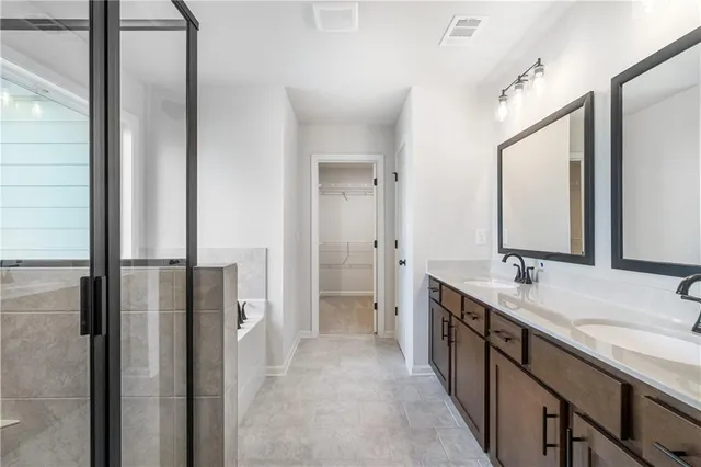 a bathroom with a bathtub and a shower