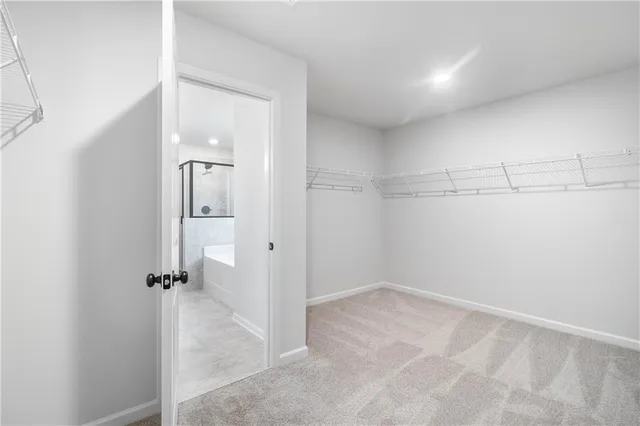 a view of a room with wooden floor and kitchen view