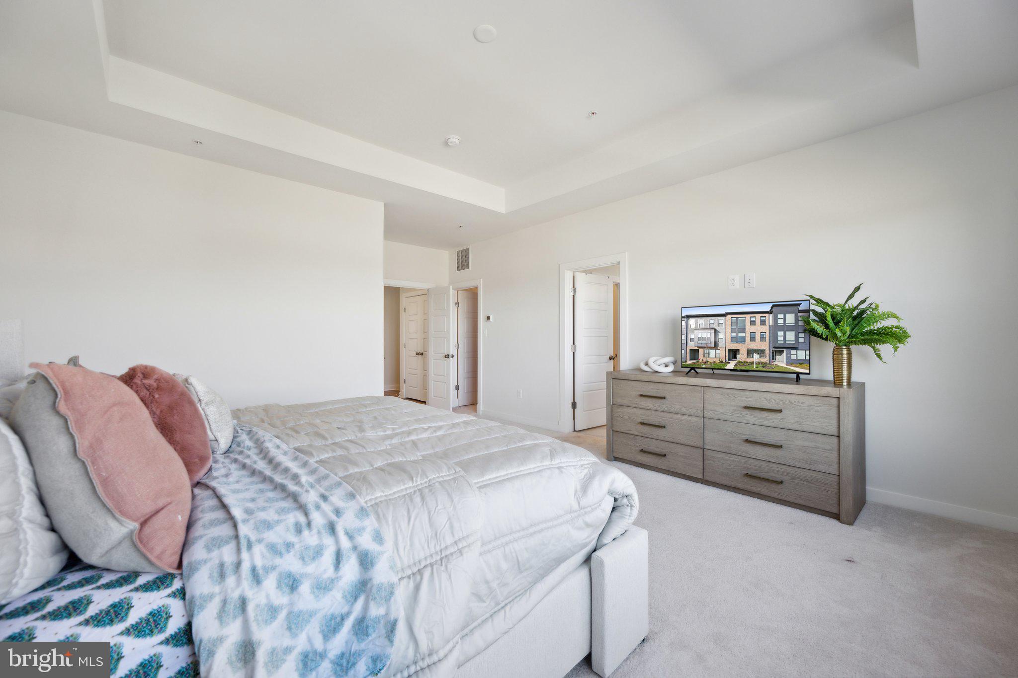 319 Summit Point Boulevard Bowie, MD 20716 - Photo 11 of 28 a bedroom with a bed and a dresser