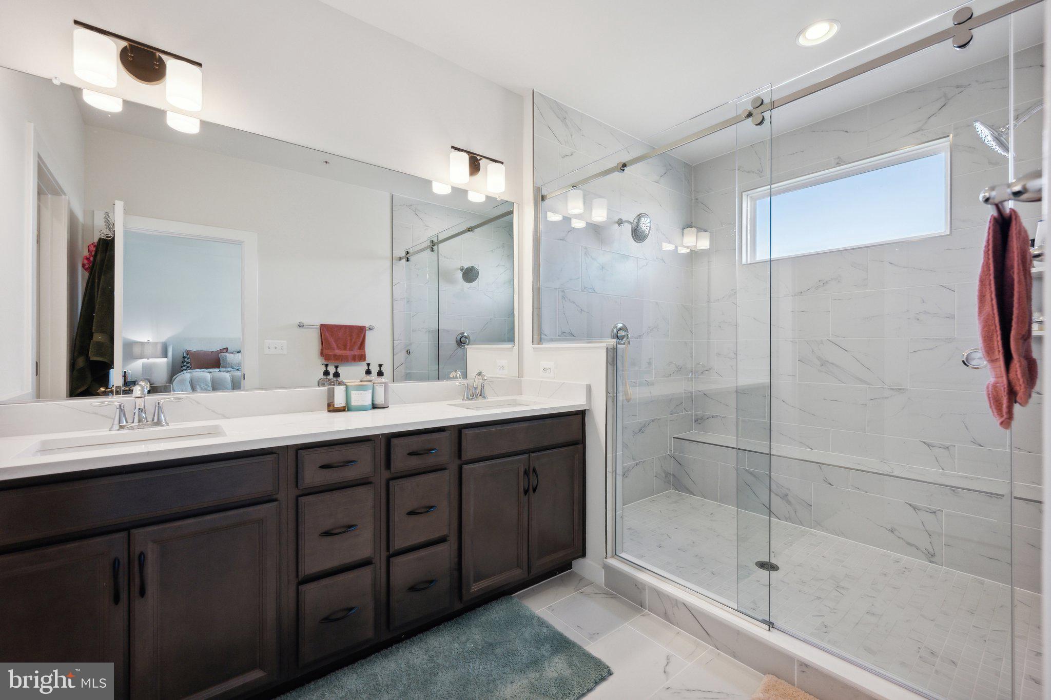 319 Summit Point Boulevard Bowie, MD 20716 - Photo 12 of 28 a bathroom with a double vanity sink mirror and shower