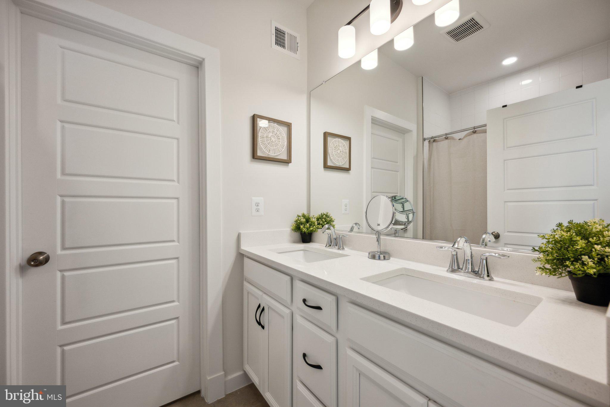 319 Summit Point Boulevard Bowie, MD 20716 - Photo 17 of 28 a bathroom with a sink vanity and a mirror
