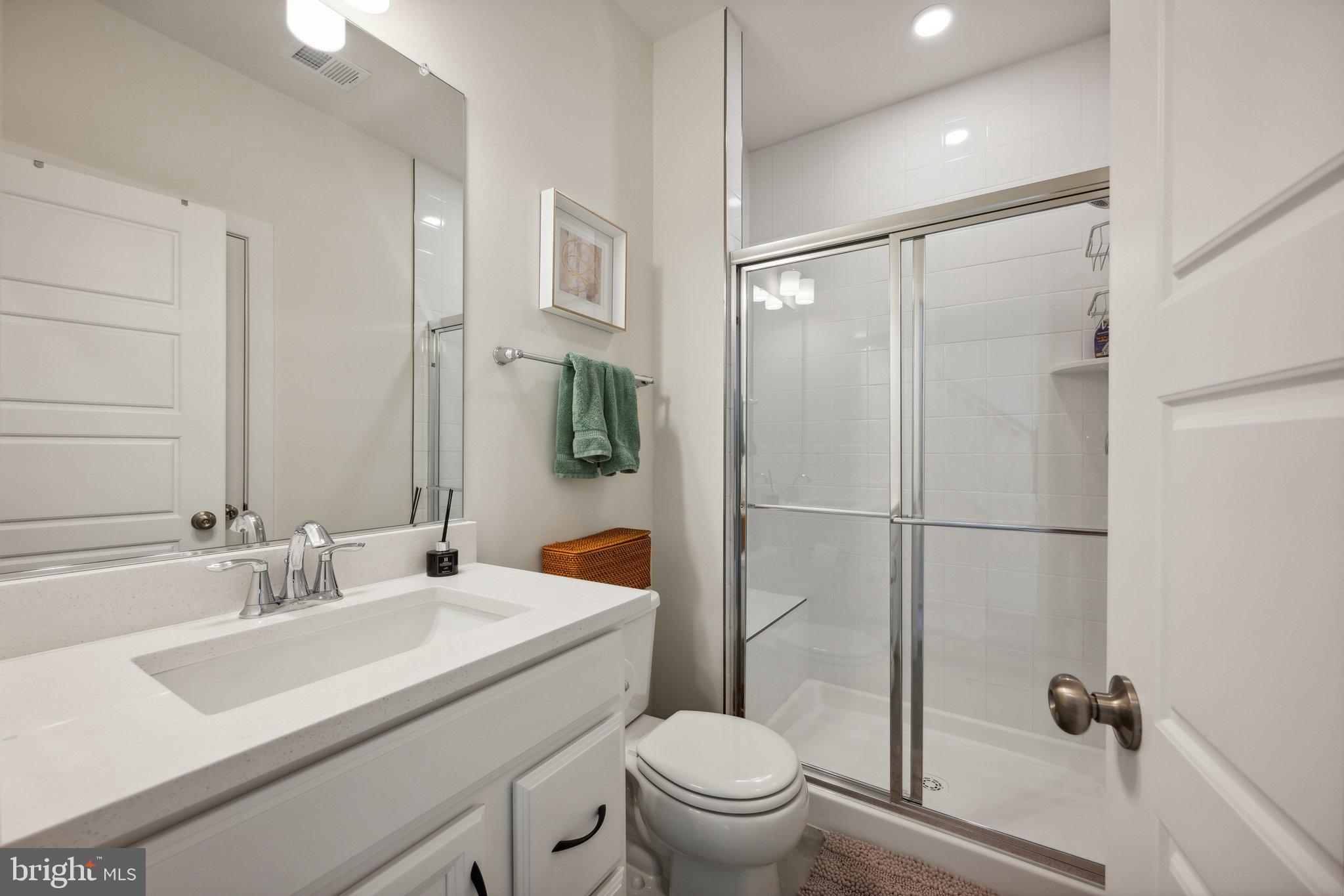 319 Summit Point Boulevard Bowie, MD 20716 - Photo 18 of 28 a bathroom with a sink toilet and shower