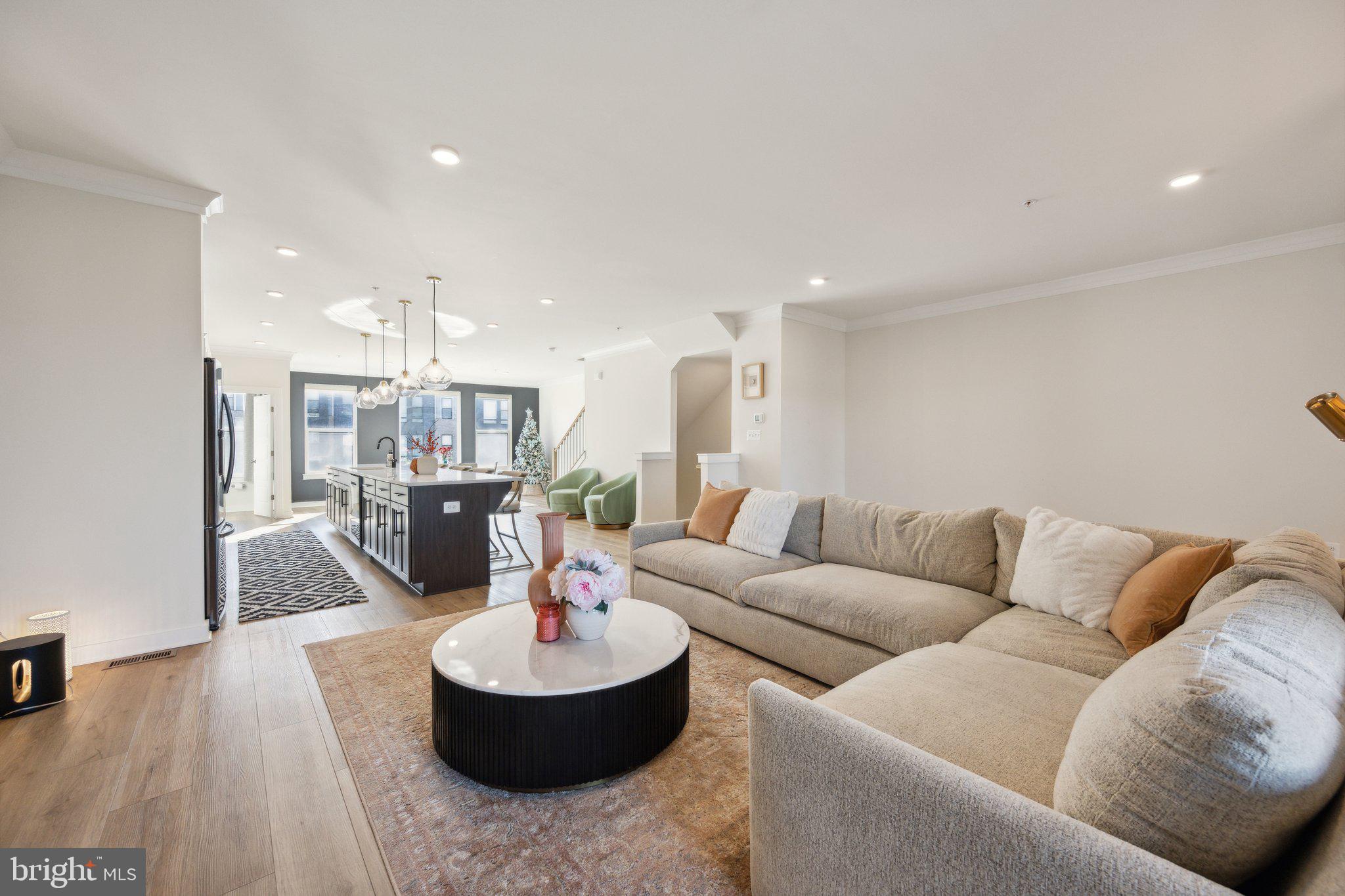 319 Summit Point Boulevard Bowie, MD 20716 - Photo 2 of 28 a living room with furniture and a dining table