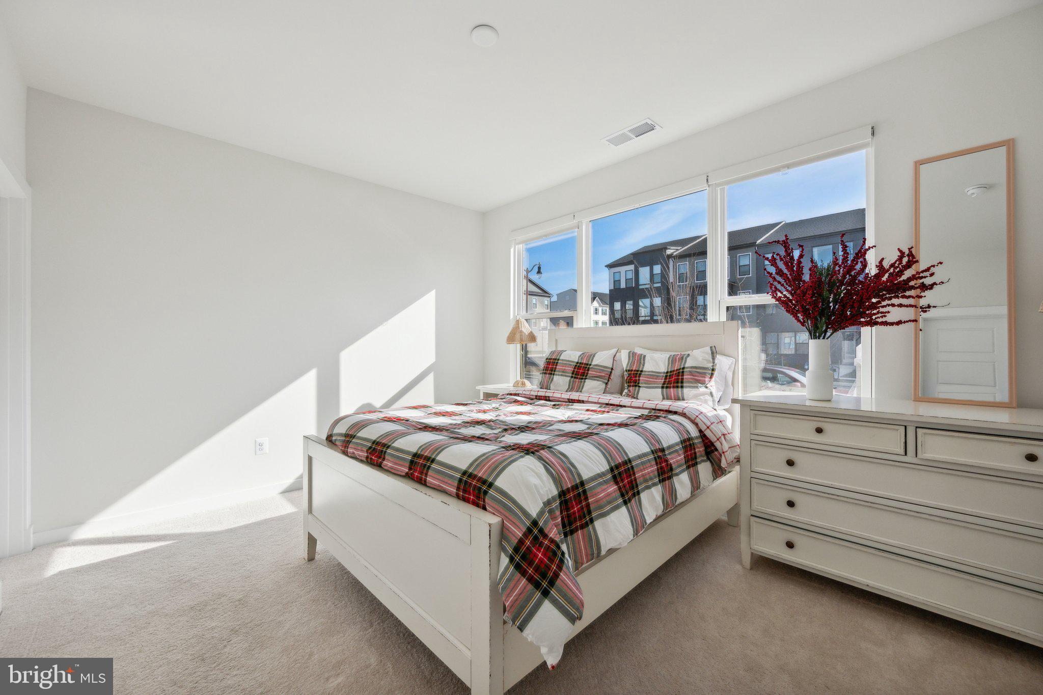 319 Summit Point Boulevard Bowie, MD 20716 - Photo 21 of 28 a bed room with a bed and a potted plant