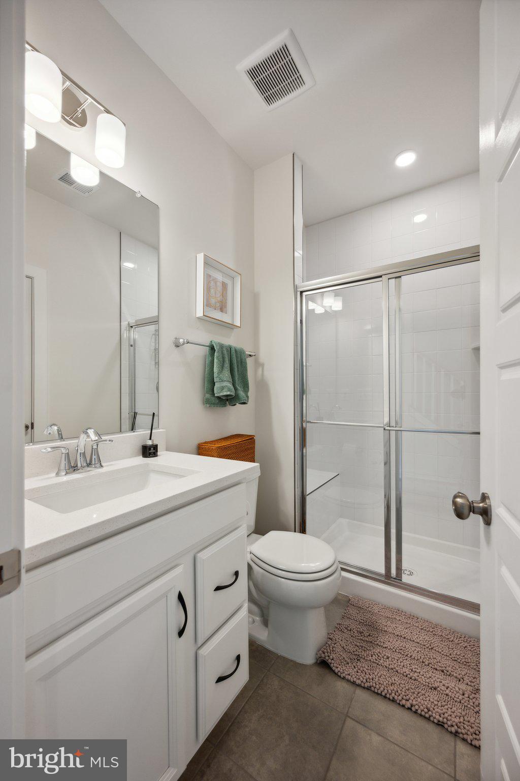 319 Summit Point Boulevard Bowie, MD 20716 - Photo 23 of 28 a bathroom with a sink toilet and shower