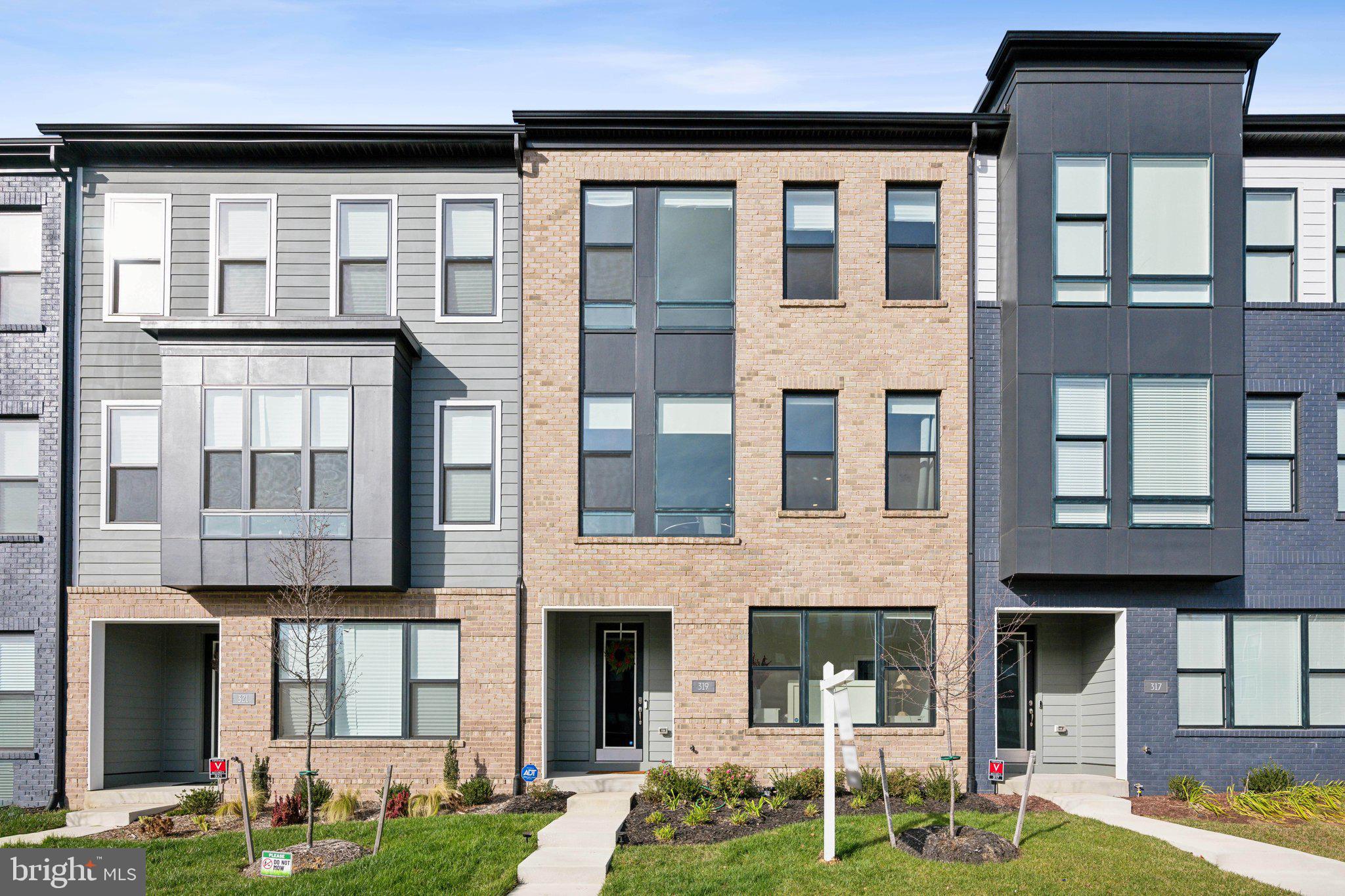 319 Summit Point Boulevard Bowie, MD 20716 - Photo 28 of 28 a front view of a brick house with a yard