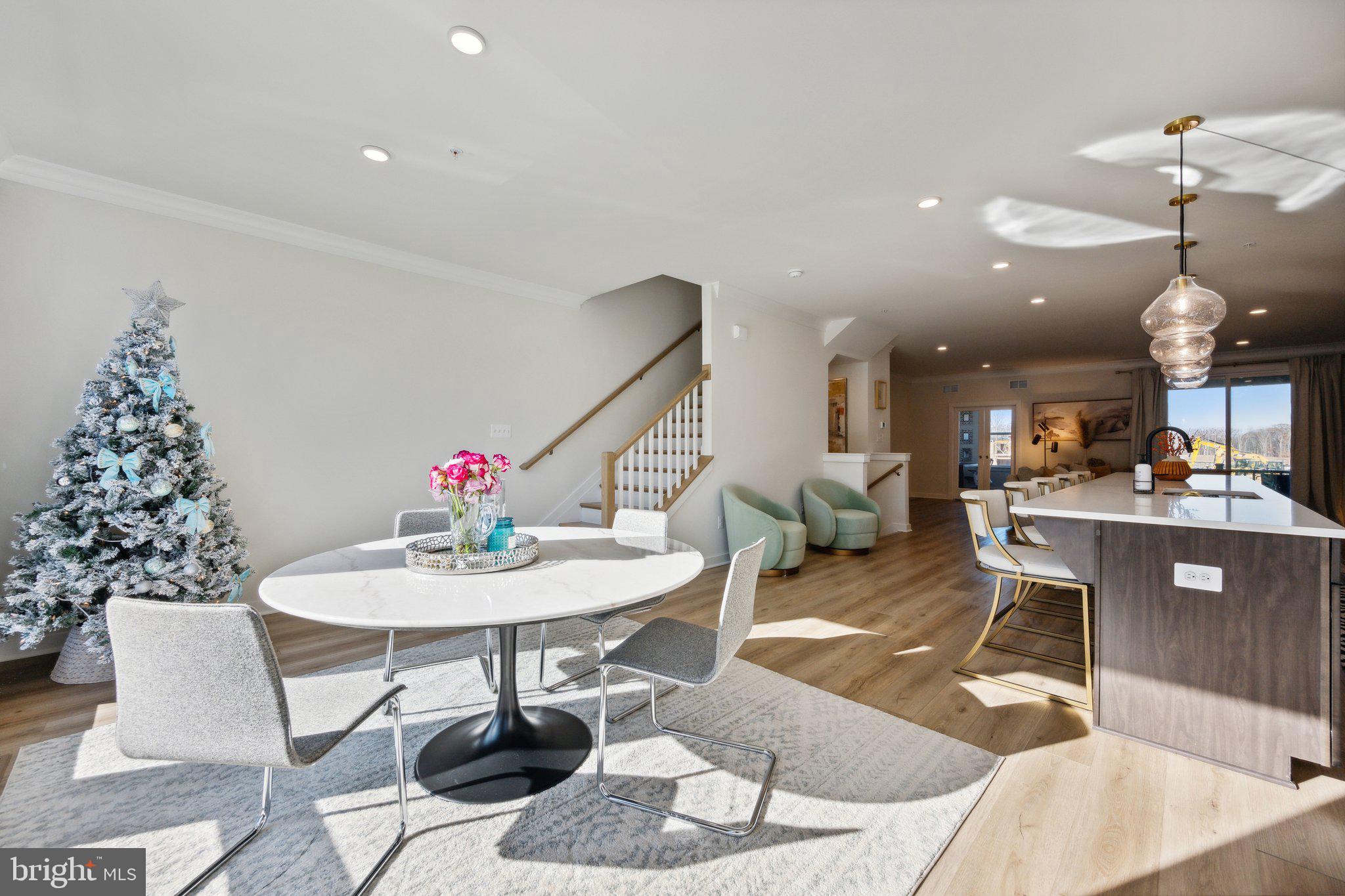 319 Summit Point Boulevard Bowie, MD 20716 - Photo 6 of 28 a living room with furniture a chandelier and a dining table