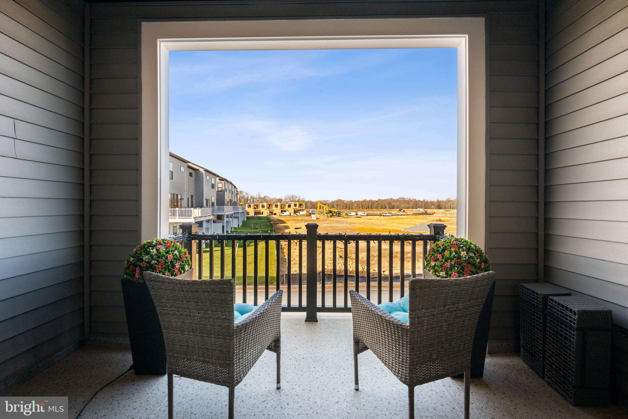 319 Summit Point Boulevard Bowie, MD 20716 - Photo 8 of 28 a balcony with a couch and wooden floor