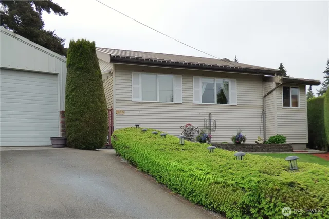 a view of a house with a yard and garage