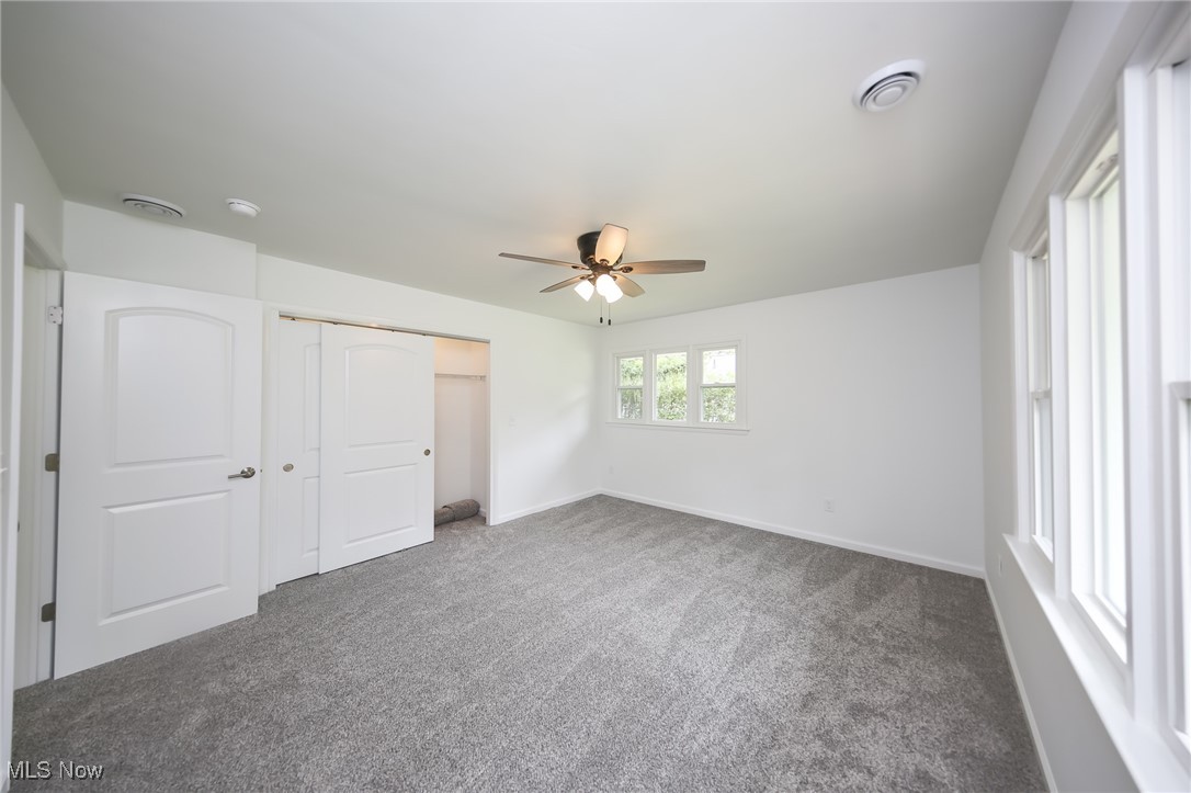 6544 Neff Road Valley City, OH 44280 - Photo 27 of 45 Unfurnished bedroom with a closet, carpet, and ceiling fan