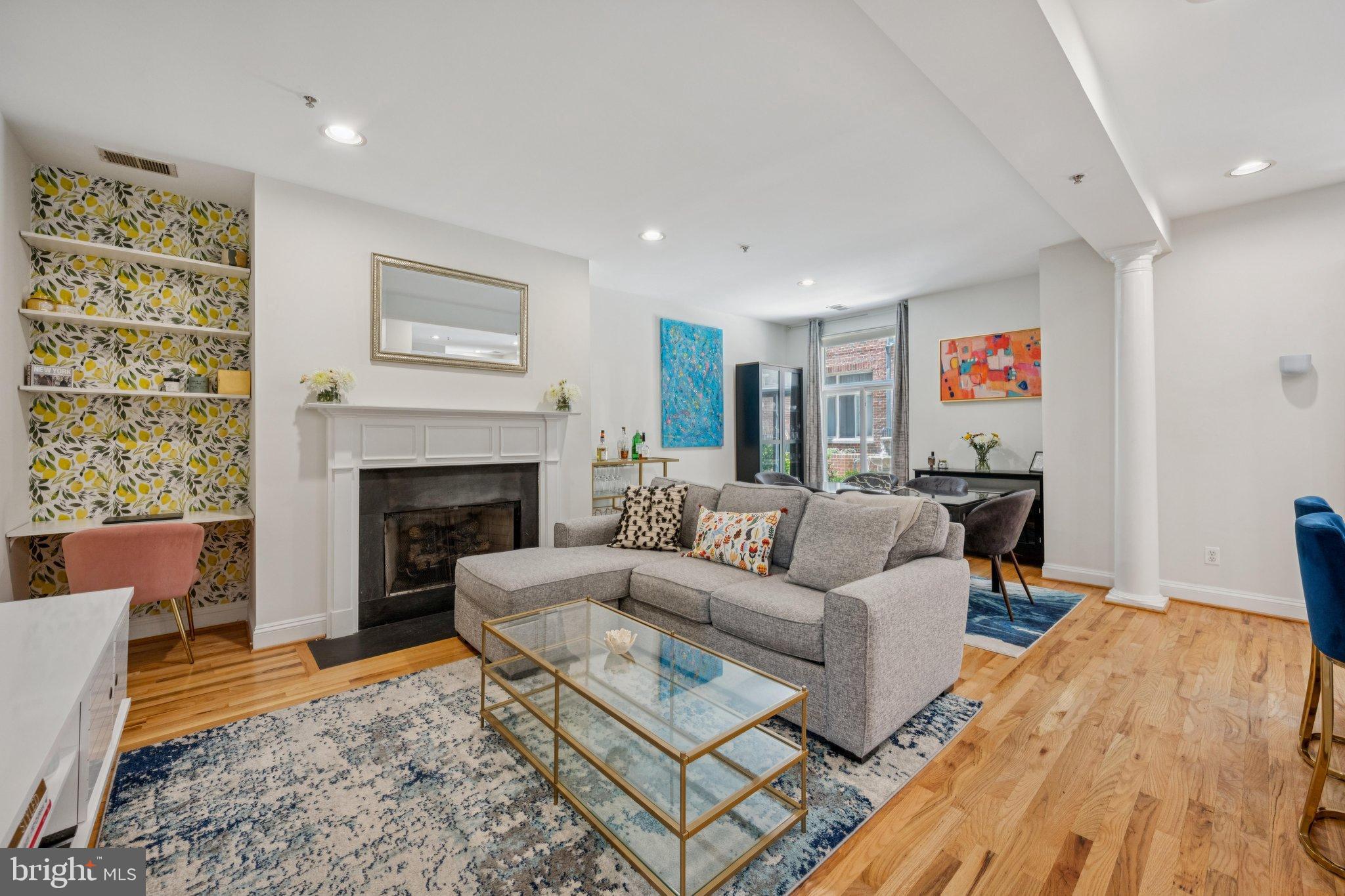 a living room with furniture and a fireplace
