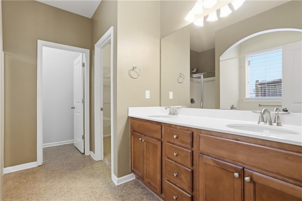 236 Manous Way Canton, GA 30115 - Photo 18 of 25 a bathroom with a granite countertop sink mirror and double
