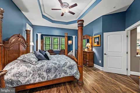 a bedroom with a large bed and a chandelier